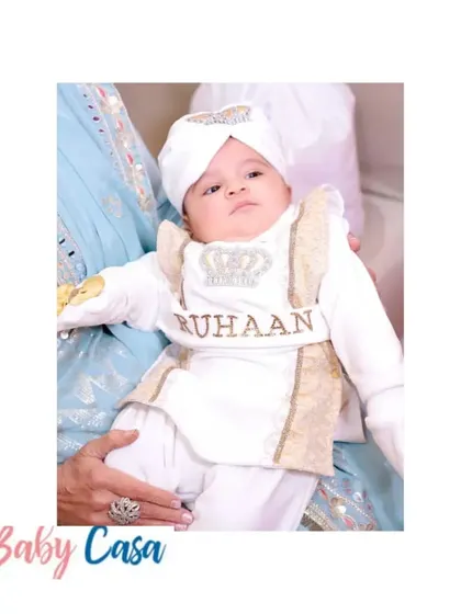 A beautiful family portrait from a Lohri celebration. The little boys are dressed in matching white and gold traditional outfits, personalized with their names, Ruhaan and Aryaveer.
