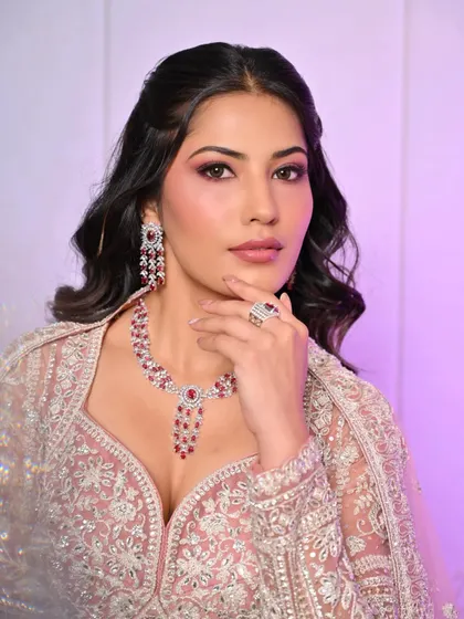 A confident portrait of the model, showcasing the beautiful blend of the pink-toned makeup.