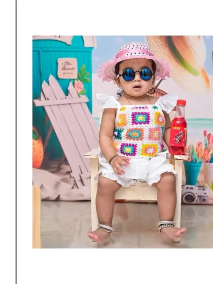 Chilling out in style for a beach-themed portrait. I provide fun accessories like these sunglasses and a colorful outfit to match the seaside backdrop perfectly.