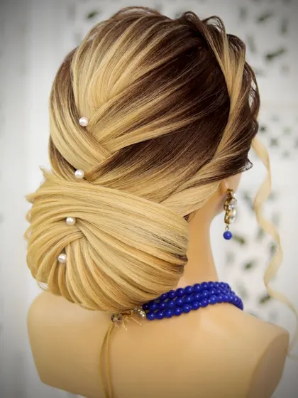 This low criss-cross bun is a beautiful and intricate wedding hairstyle. The interwoven sections create a stunning texture that looks amazing from all angles.