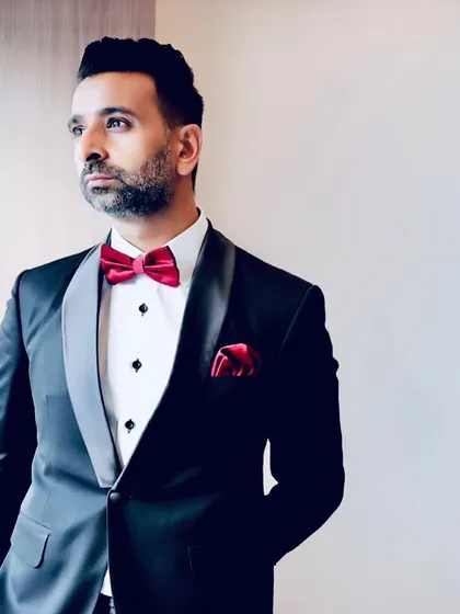 A profile shot highlighting the clean lines of the tuxedo jacket and the confident posture it inspires. Every detail, from the lapel to the buttons, is carefully considered.