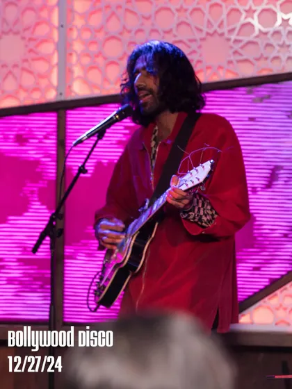 A guitarist from The Kominas performing a solo during their special Bollywood Disco set. It's all about creating rare, unforgettable musical moments.