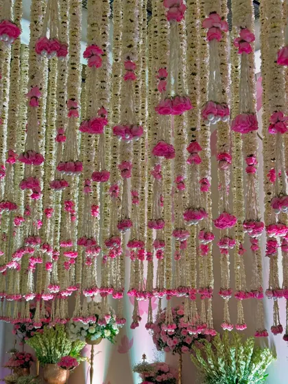 More views of the magical entrance, highlighting the density of the floral ceiling, the elegant decor pieces, and the soft, inviting lighting.
