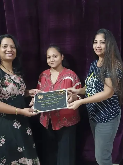 Presenting a certificate to a student after she completed the saree draping workshop.
