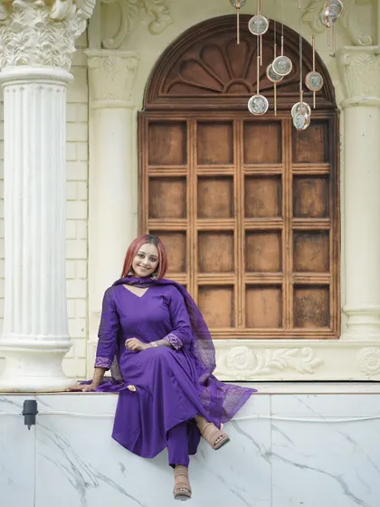 A relaxed and confident pose on a marble ledge, with a classic window providing a simple yet elegant backdrop.