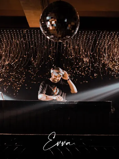 In my element under the disco ball at Evva, Delhi. A great DJ set is about reading the room and creating a vibe, and this shot captures that moment of focus before the beat drops. This is the atmosphere I create for high-energy club nights and private parties.