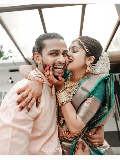 A playful and affectionate moment with the bride playfully biting the groom's cheek.