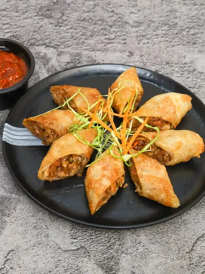 My crispy vegetable spring rolls, cut and served with a tangy dipping sauce. They are a perfect starter or snack for any time of the day.