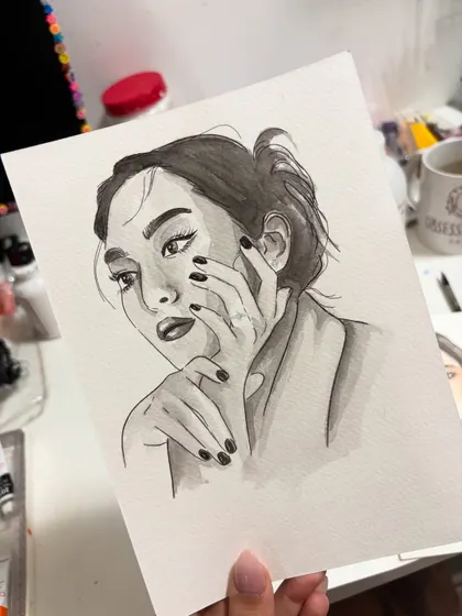 A simple and expressive black and white watercolor sketch. This style of portraiture is perfect for capturing a mood or a fleeting expression with minimal lines and shading.