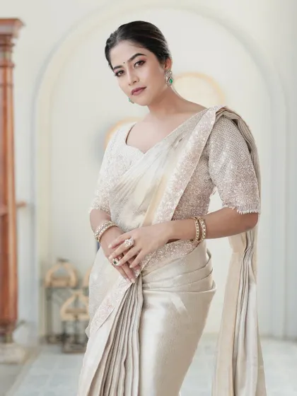 A full-length view of the ivory tissue silk saree, a perfect choice for a reception or a modern bride.