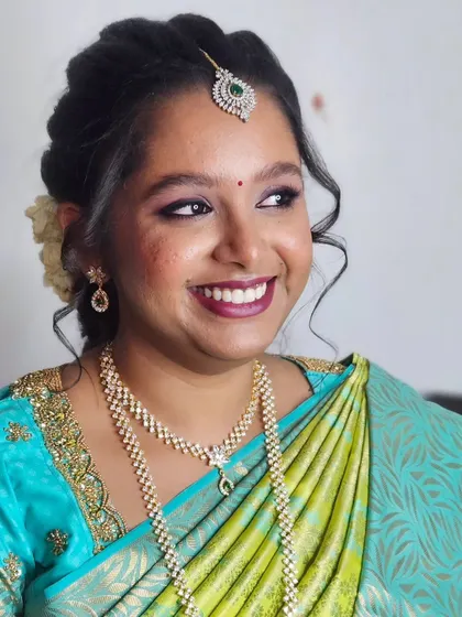Jebha's engagement glam, showing her beautiful smile. The makeup is designed to enhance her natural features and make her feel confident.