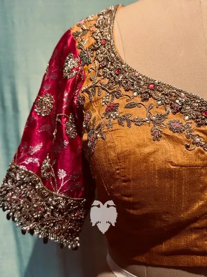 The front view, showing the jeweled neckline and floral creeper motif.