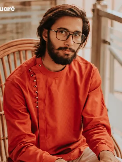 Experience the fusion of modern design and traditional comfort with our custom kurtas. This rust-orange kurta features a contemporary side-placket with loop buttons, offering a stylish and unique option for casual gatherings and festive occasions.