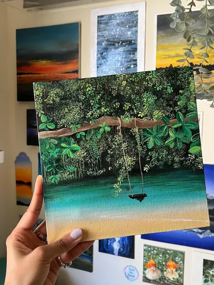 Another shot of me holding the finished Maui painting, showing how it looks against the backdrop of my other art.