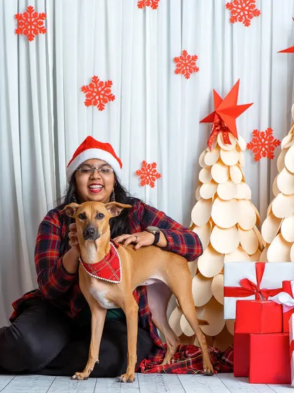 This proud dog mom and her indie dog are ready for Santa! The matching plaid and Santa hat make for an adorable and festive Christmas portrait.