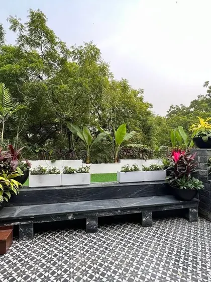 The beauty of a small roof garden adjoining a living room. This picture, taken right after planting, shows how colorful planters and a patterned tile floor can instantly liven up a space.