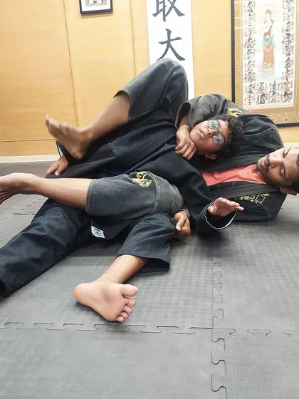 Repetition is key to learning. Here, a student practices maintaining the mount position, building muscle memory for one of the most dominant positions in jiu-jitsu.