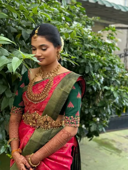 Ragavi in a moment of quiet contemplation. The soft makeup look is perfect for capturing these gentle, emotional moments during the wedding day.