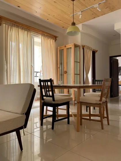 This space understood the assignment: cozy, airy, and effortlessly aesthetic. A simple and elegant dining setup with light wood furniture.
