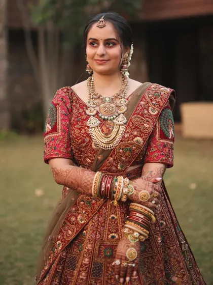 A real bride looking radiant with a gentle, low updo. This hairstyle is perfect for supporting heavy jewellery and a dupatta without feeling too severe.