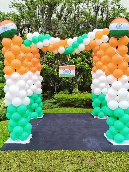 An outdoor balloon arch in the colors of the Indian flag, created for an Independence Day celebration at a corporate campus or residential society.