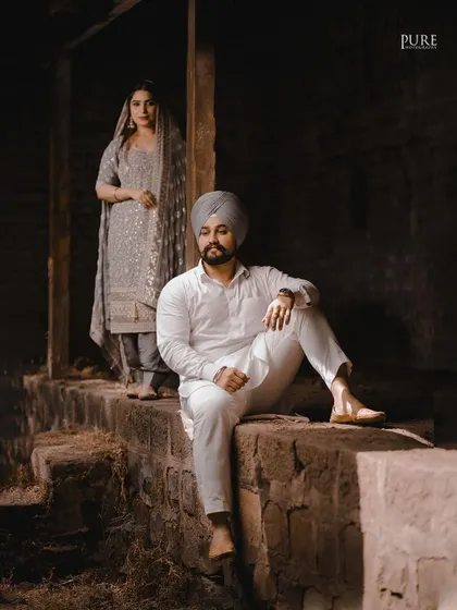A more artistic, moody portrait from Aman and Simran's session. The focus on him in the foreground with her in the back creates a story and adds a cinematic quality to the image.