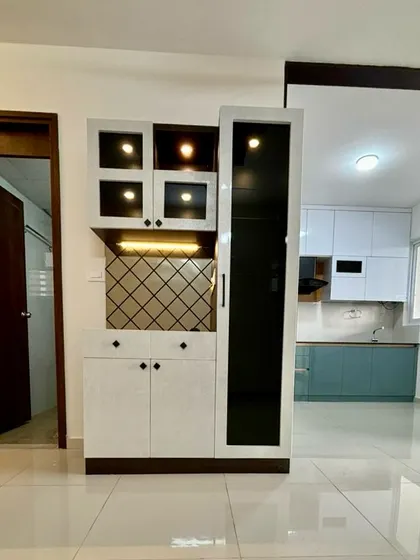 A view from the entryway showing the crockery unit and a glimpse into the modern two-tone kitchen.