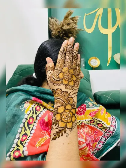 A single hand showcasing a beautiful rose-themed design.