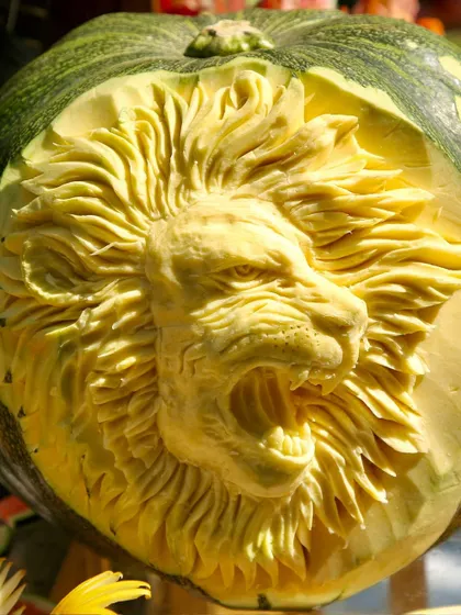 My fruit displays often feature intricate fruit carvings, like this stunning lion face carved into a pumpkin, adding a true "wow" factor to the decor.