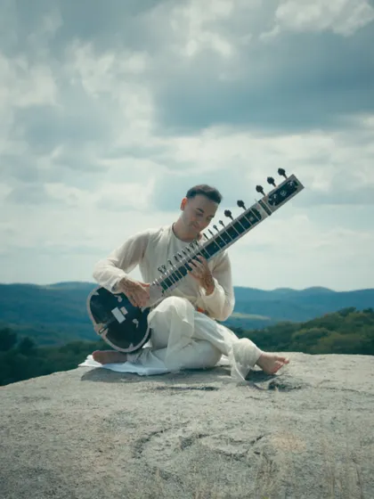 A still from the 'Shankara' music video, capturing the serene, natural setting of the shoot.