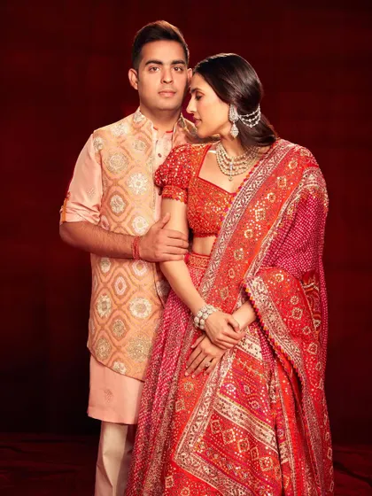 A beautiful portrait of Shloka and Akash Ambani. The red Abu Jani Sandeep Khosla lehenga is a perfect example of classic bridal and festive wear.