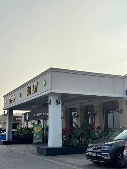 A daytime view of our bustling food mall, showing the variety of storefronts like Ajfan and Starbucks.
