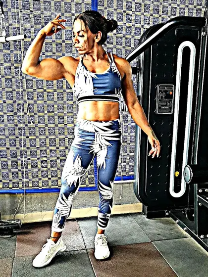 Striking a pose to show my arm and shoulder development. I teach my clients how to eat for performance and aesthetics, so you not only get stronger but also look the part.