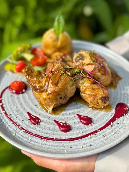 A beautifully plated Halgali's Roast Chicken, showcasing the tender meat and rich sauce.