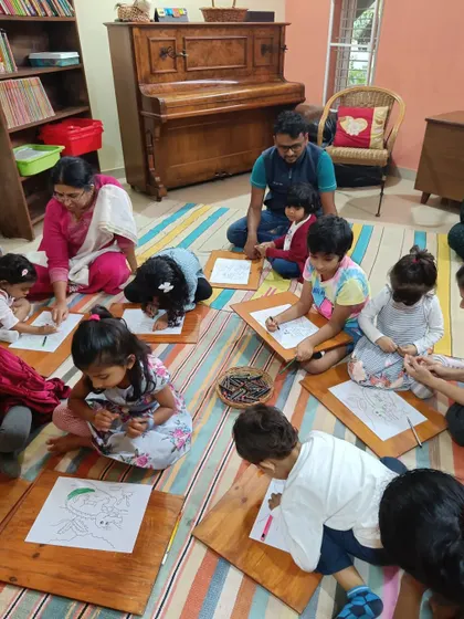A close up of the children's hands at work during the drawing session.