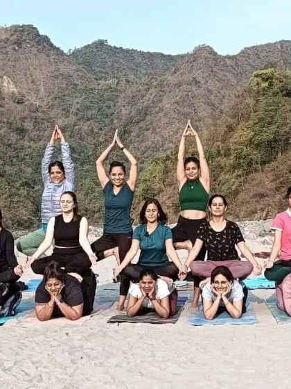 A creative group asana by the river, showing the strength and coordination we build as a community.