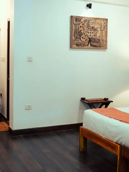 A different angle of our spacious group accommodation, featuring comfortable beds and artistic touches.