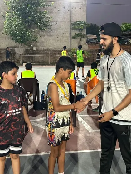A handshake of respect. Congratulating a young player for his performance during the Warriors vs INSFIRE Under-10 match.