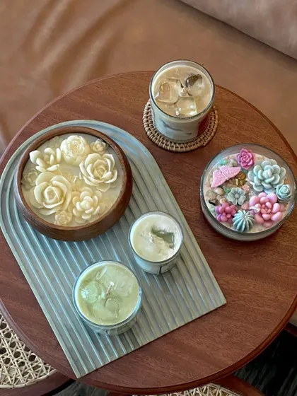 Our bestselling products in one frame. This shot features my floral wooden urli and a succulent garden candle, showing the versatility of my earthy designs.