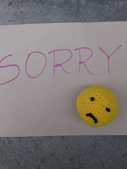 A simple note with my handmade sad emoji amigurumi.