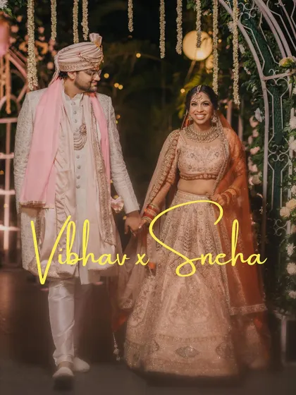 A beautiful wedding portrait of the couple, with their names elegantly written. The festive lighting and their happy expressions make this a perfect memory.