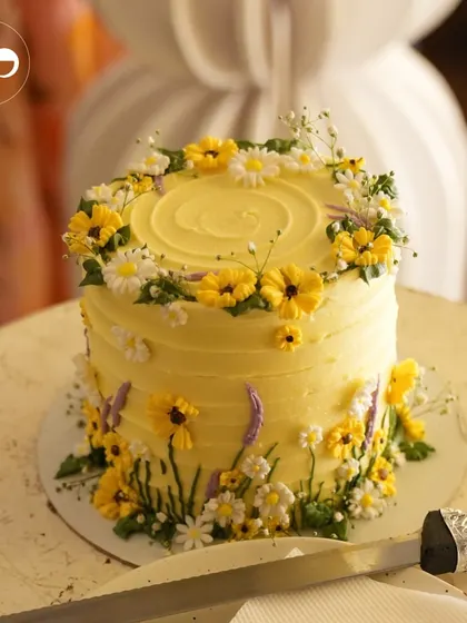 A beautiful yellow cake decorated with delicate, hand-crafted sugar flowers. This was the perfect sweet treat for a 'Baby in Bloom' honeybee-themed shower.