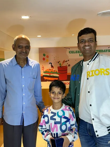 A student with his family after receiving his award at the Abacus prize distribution event. It's a community effort, and I'm grateful for the support of our students' families.