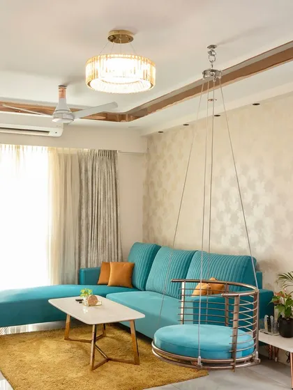 Another angle of the lively living room, highlighting the balance between the bold colors of the furniture and the neutral, textured wallpaper.