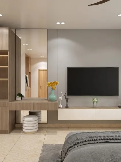 Functionality is key in hospitality design. This image showcases the room's amenities, including a well-lit vanity and mirror, a luggage rack, and a neatly integrated mini-bar and storage unit, all designed with a consistent modern aesthetic.