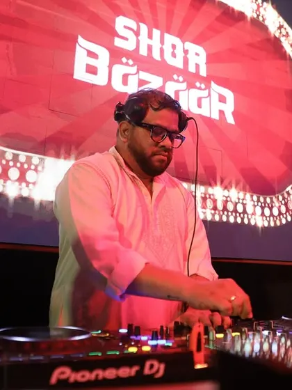 At the decks in Raipur, with the Shor Bazaar logo lighting up the screen behind me.