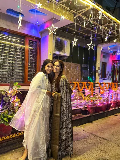 Posing with a friend during Diwali celebrations. I opted for a simple, elegant white chikankari suit that feels both festive and comfortable.