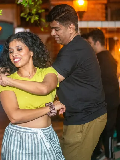 A happy, carefree moment between partners. The smiles are what make hosting these nights so rewarding.