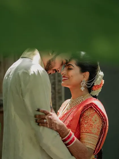 A quiet, intimate portrait framed by lush greenery. We use natural elements to create a sense of romance and tranquility in our couple's wedding photos.