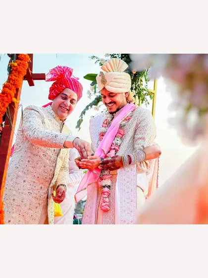 A happy moment between the groom and a family member during a beach wedding ceremony in Goa.
